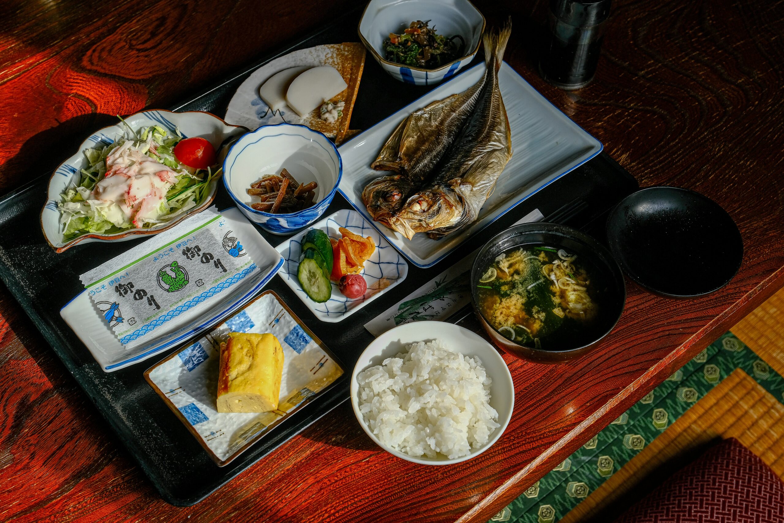 Japanese teishoku meal set with grilled fish, rice, pickles, and side dishes