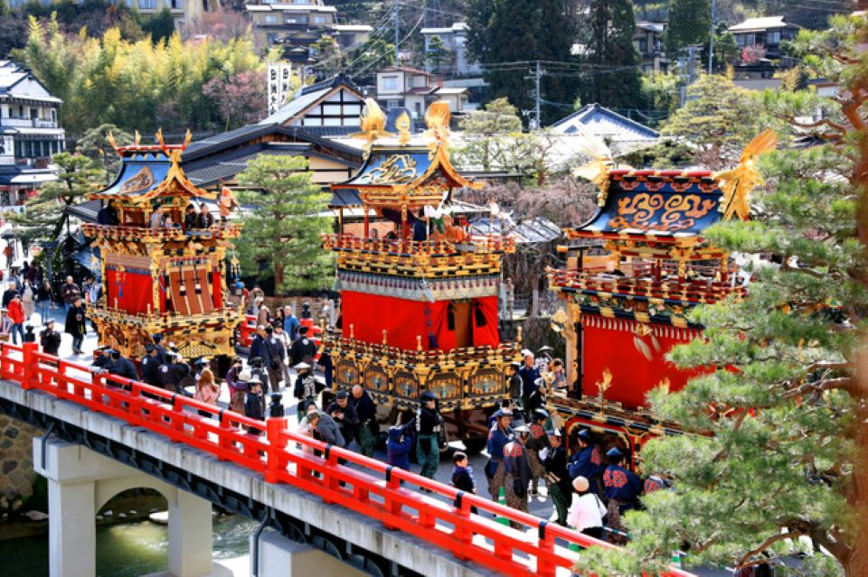 Takayama Autumn Festival parade with floats and people in traditional dress
