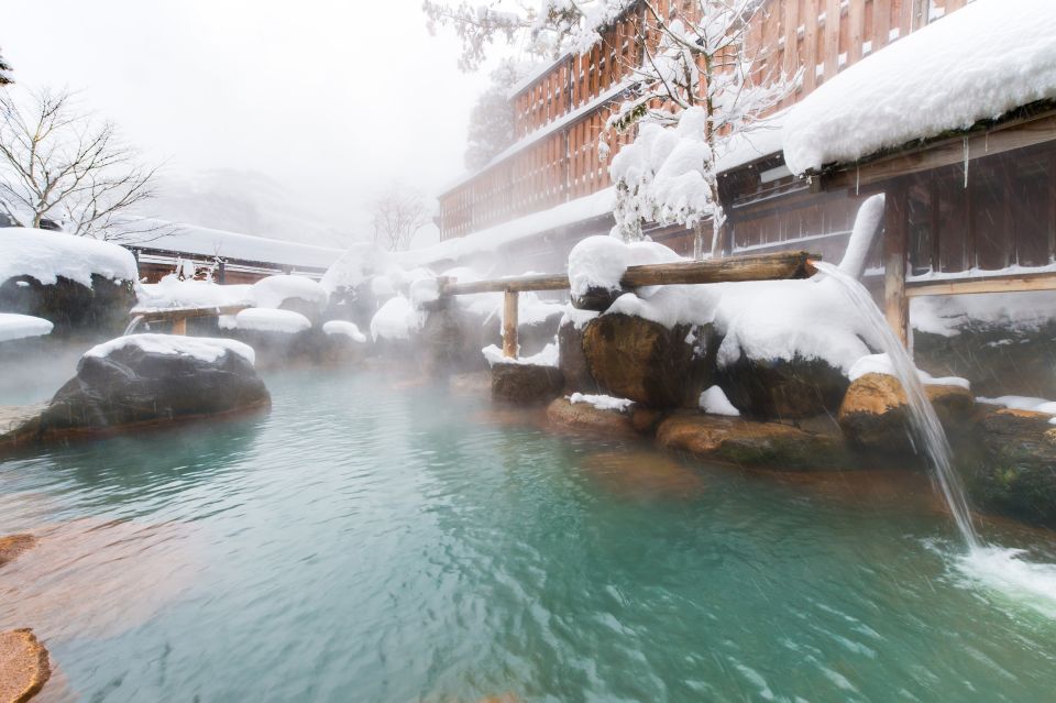 Snowy outdoor hot spring with rising steam