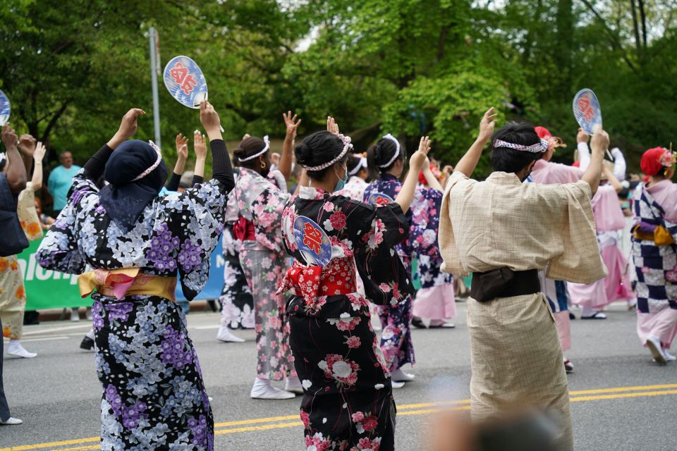 People dancing at a summer festival wearing yukata