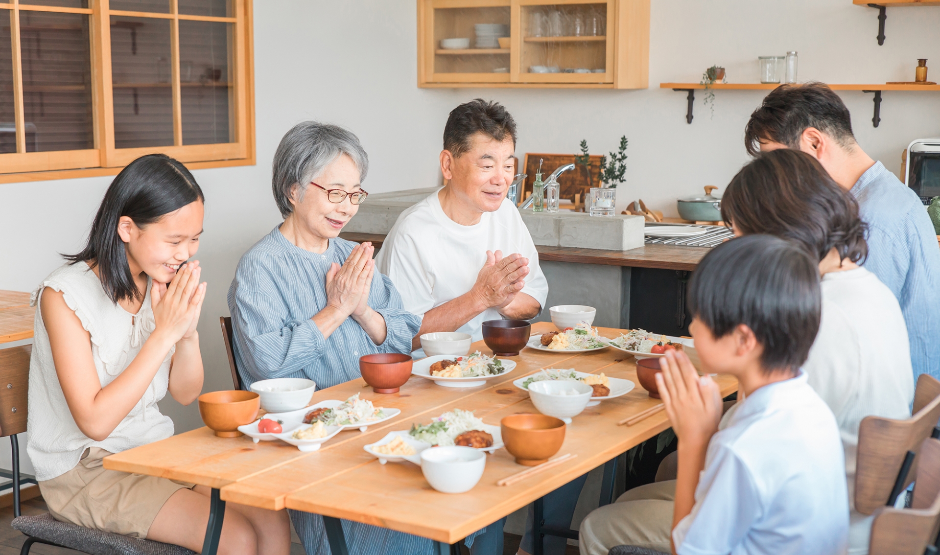 A Japanese family saying 'Itadakimasu' before a meal