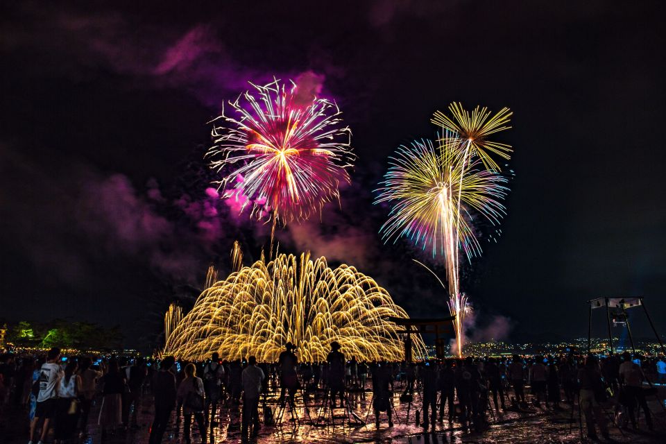 Fireworks bursting above the torii gate of Itsukushima Shrine at Miyajima