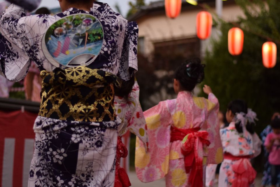People using uchiwa and sensu fans at a Japanese summer festival in yukata