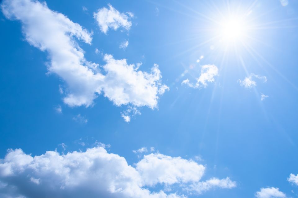 Bright summer sky in Japan with white clouds and sunshine