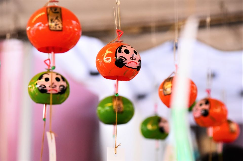 Colorful wind chimes hanging at Kawasaki Daishi Wind Chime Market in front of the temple