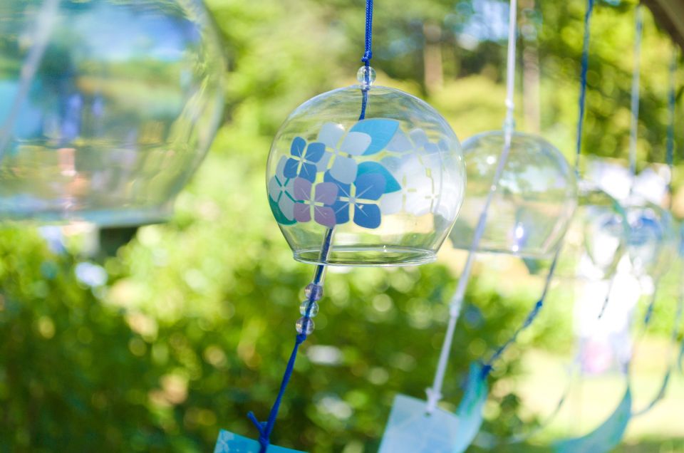 Japanese glass wind chimes hanging under a house eave in summer