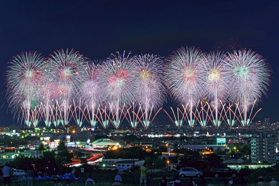 Nagaoka Fireworks Festival over Shinano River with crowds watching