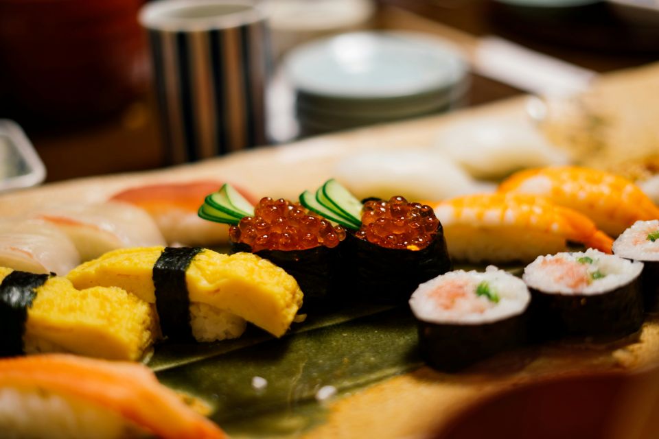 Assorted sushi pieces on a wooden tray