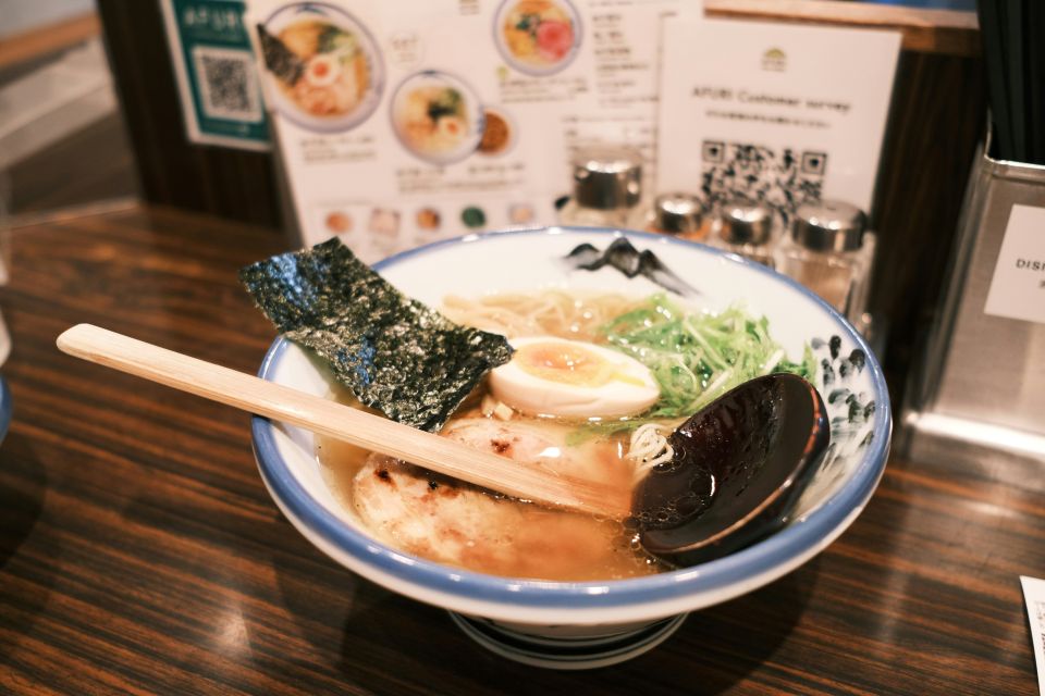 Bowl of steaming Japanese ramen with pork and egg